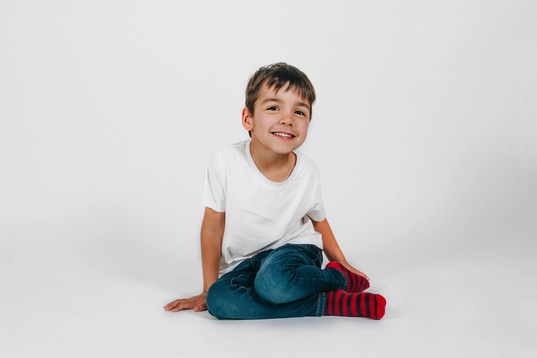 A family photographed against a plain white wall, no props and no set